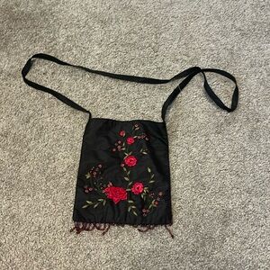 crossover bag with flower design and beads.